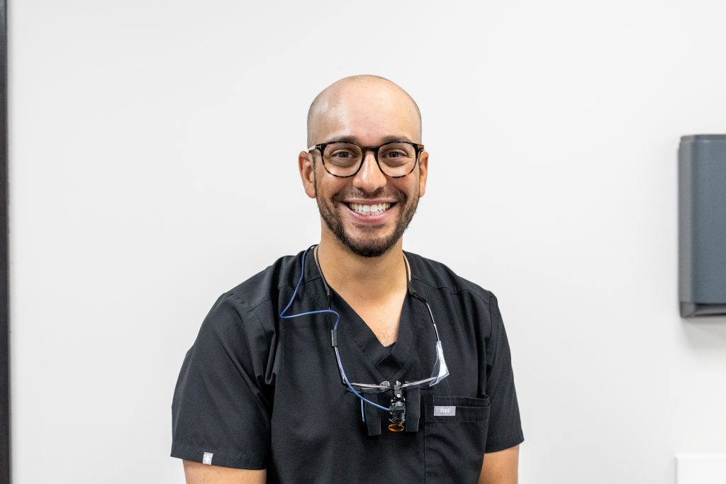A smiling dentist.